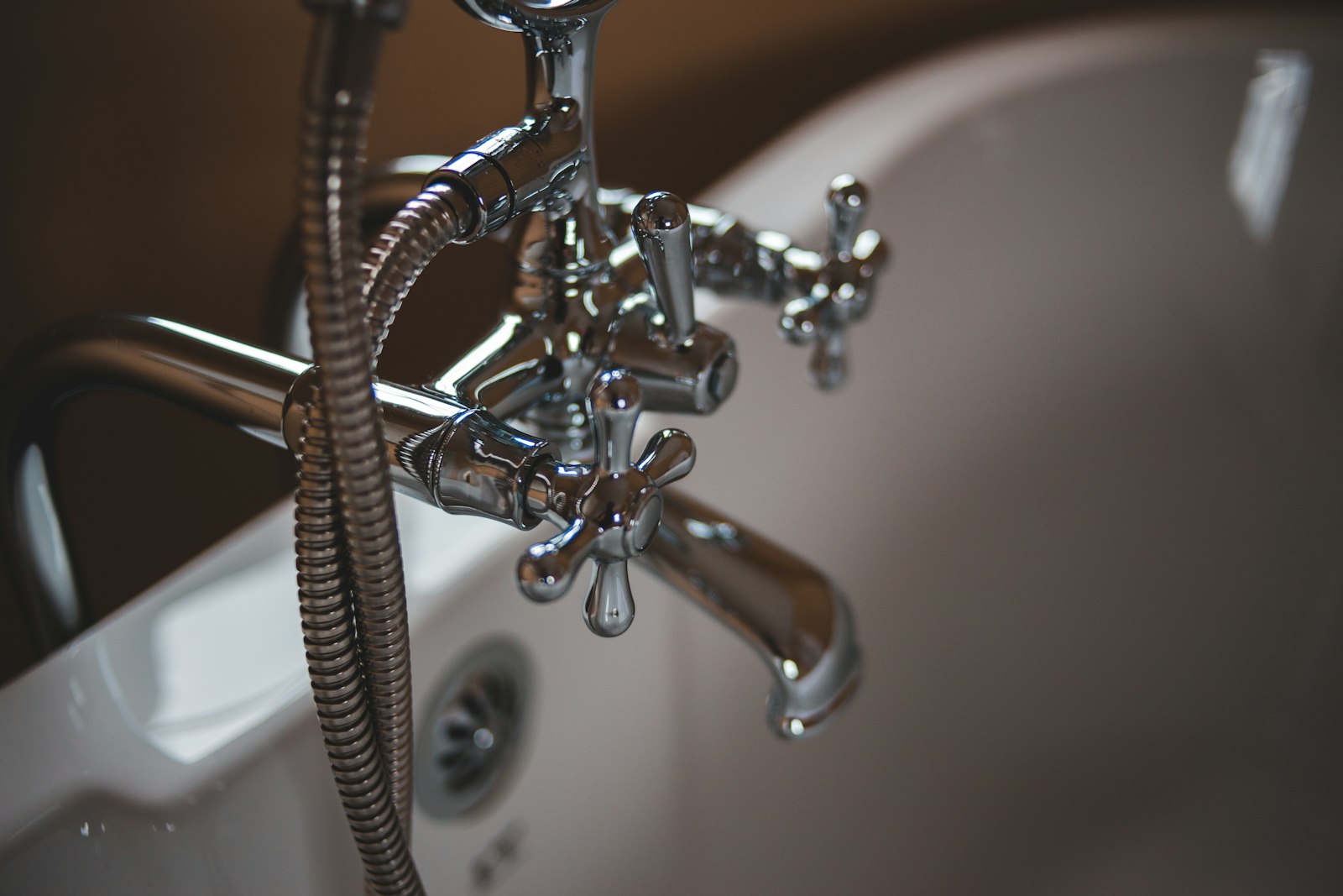 Plumber repairing water pipes under a sink